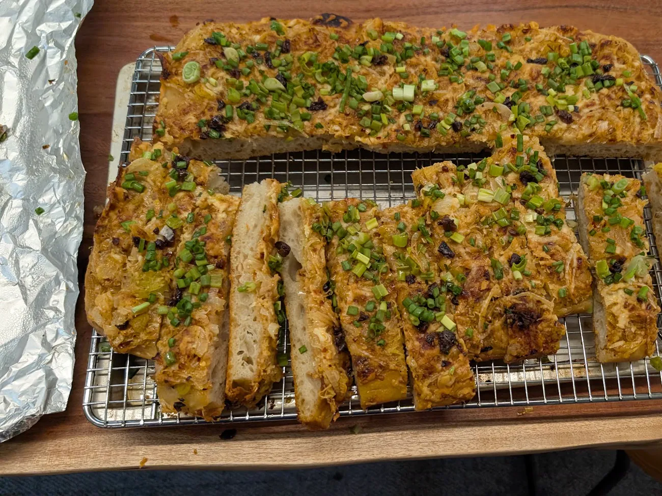The focaccia cut into strips on a cooling rack
